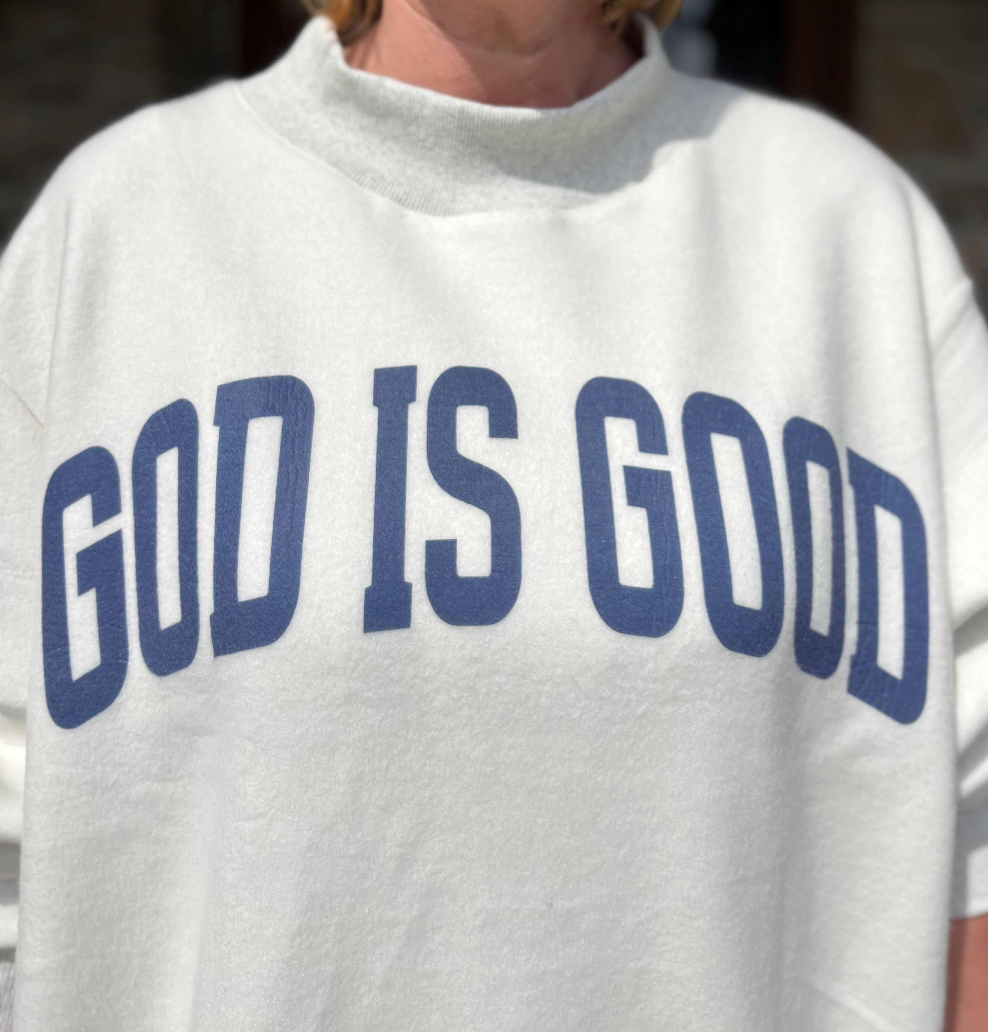 Brooke & Co God is Good/Jesus Mock Neck Sweatshirt, white & ash grey oversized sweatshirt with blue God is Good graphic up close view