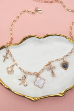 Brooke & Co gold charm necklace in dish