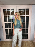 brooke & co the dani wearing a dark green and white striped short-sleeve button-up shirt