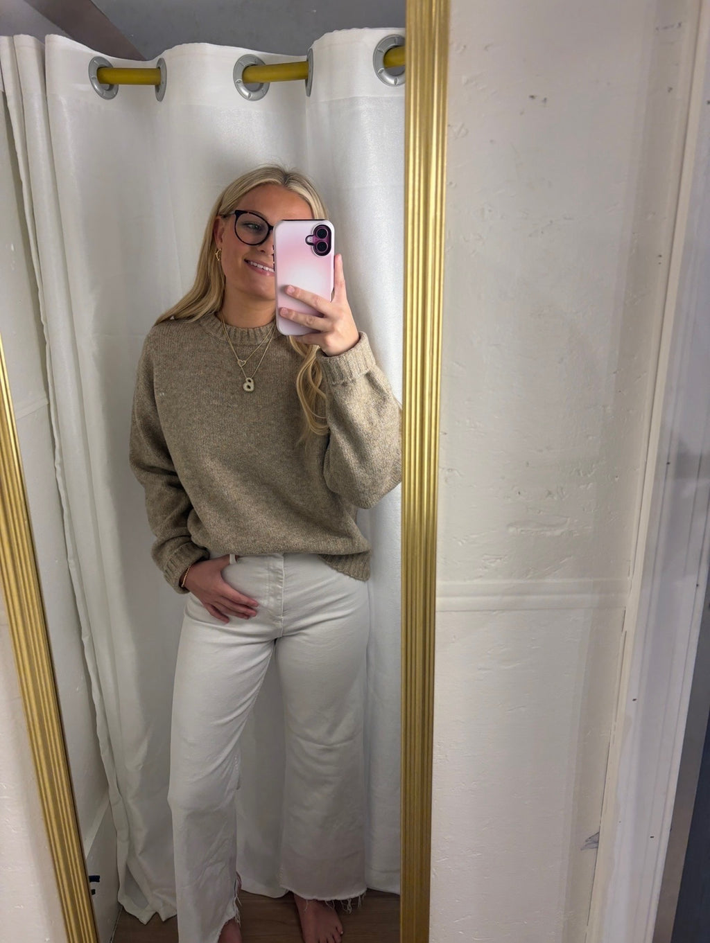 A woman wearing The Lennon Sweater that is a relaxed knit sweater with a soft brushed marled texture and crew neckline. Long sleeves, dropped shoulders, and wide ribbed trim at the cuffs and hem