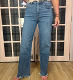 A woman wearing The Briana Jeans, featuring a super high rise waist and loose, vintage-inspired silhouette. Crafted from comfortable stretch denim in a medium wash.