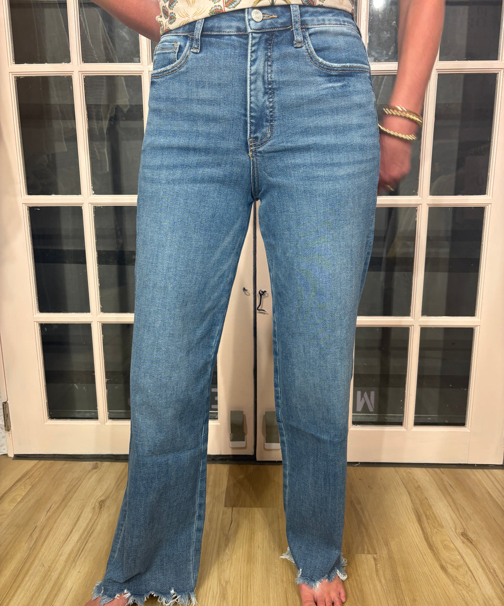 A woman wearing The Briana Jeans, featuring a super high rise waist and loose, vintage-inspired silhouette. Crafted from comfortable stretch denim in a medium wash.