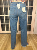 A woman wearing The Briana Jeans, featuring a super high rise waist and loose, vintage-inspired silhouette. Crafted from comfortable stretch denim in a medium wash.