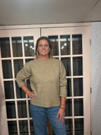 A woman wearing The Lennon Sweater that is a relaxed knit sweater with a soft brushed marled texture and crew neckline. Long sleeves, dropped shoulders, and wide ribbed trim at the cuffs and hem
