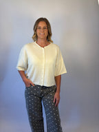 brooke & co the desi sweater Crafted from a soft knit blend, this relaxed boxy sweater features a classic round neckline, drop shoulders, and elbow length sleeves