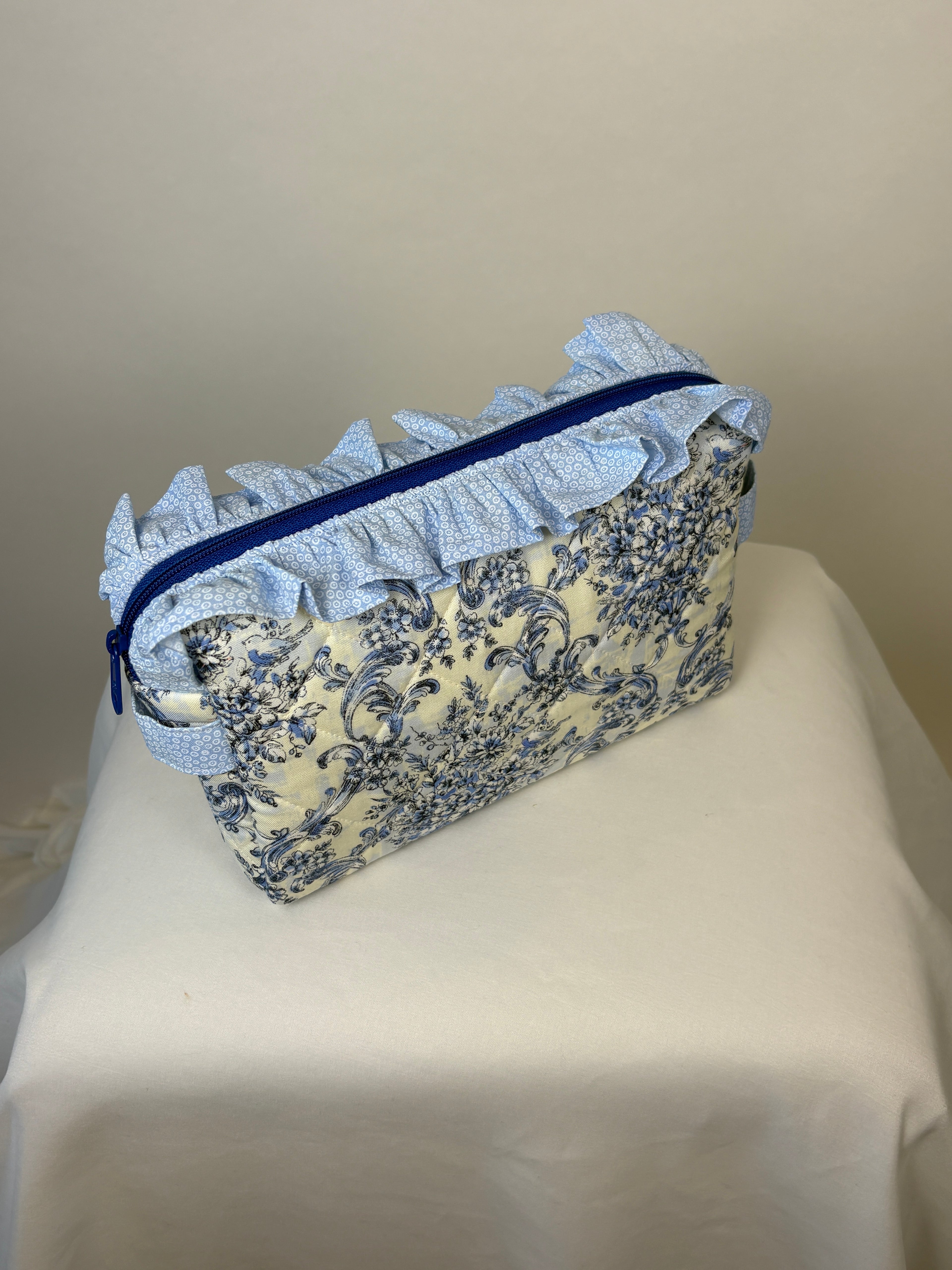 Brooke & Co ruffle beauty bag with ruffle trip detail and zipper