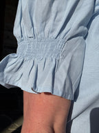 brooke & co light blue soft skies top sleeve detail showing smocked cuff and subtle texture