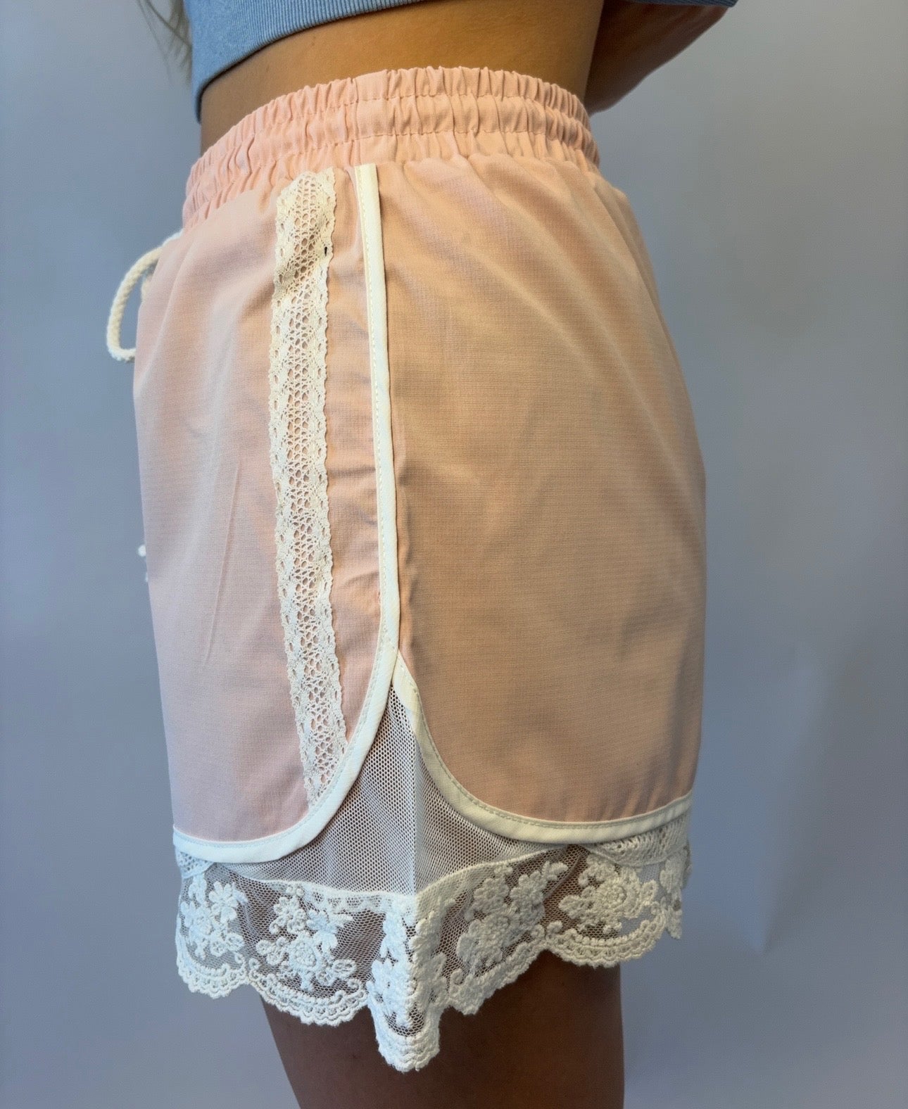 Brooke & Co blush lace athletic shorts in blush pink with lace trim and drawstring waist side detail view
