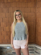 brooke & co blue haven top blue smocked sleeveless top with peplum hem and fitted bodice bow ties on the side close view