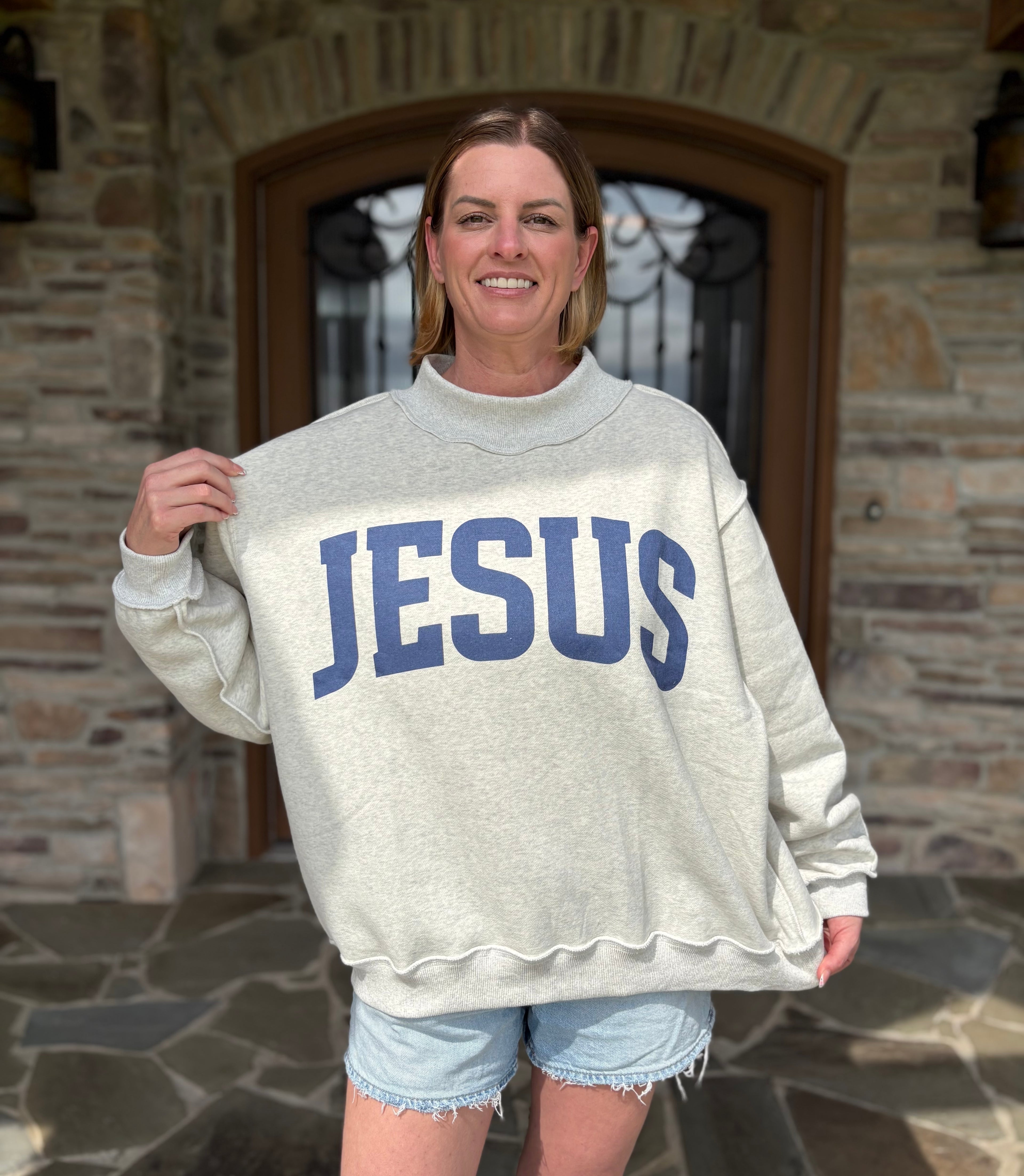 Brooke & Co God is Good/Jesus Mock Neck Sweatshirt, white & ash grey oversized sweatshirt with blue graphic holding front view