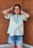 Brooke & Co spring meadow top showing smocked sleeve cuffs and relaxed fit in blue and green floral print