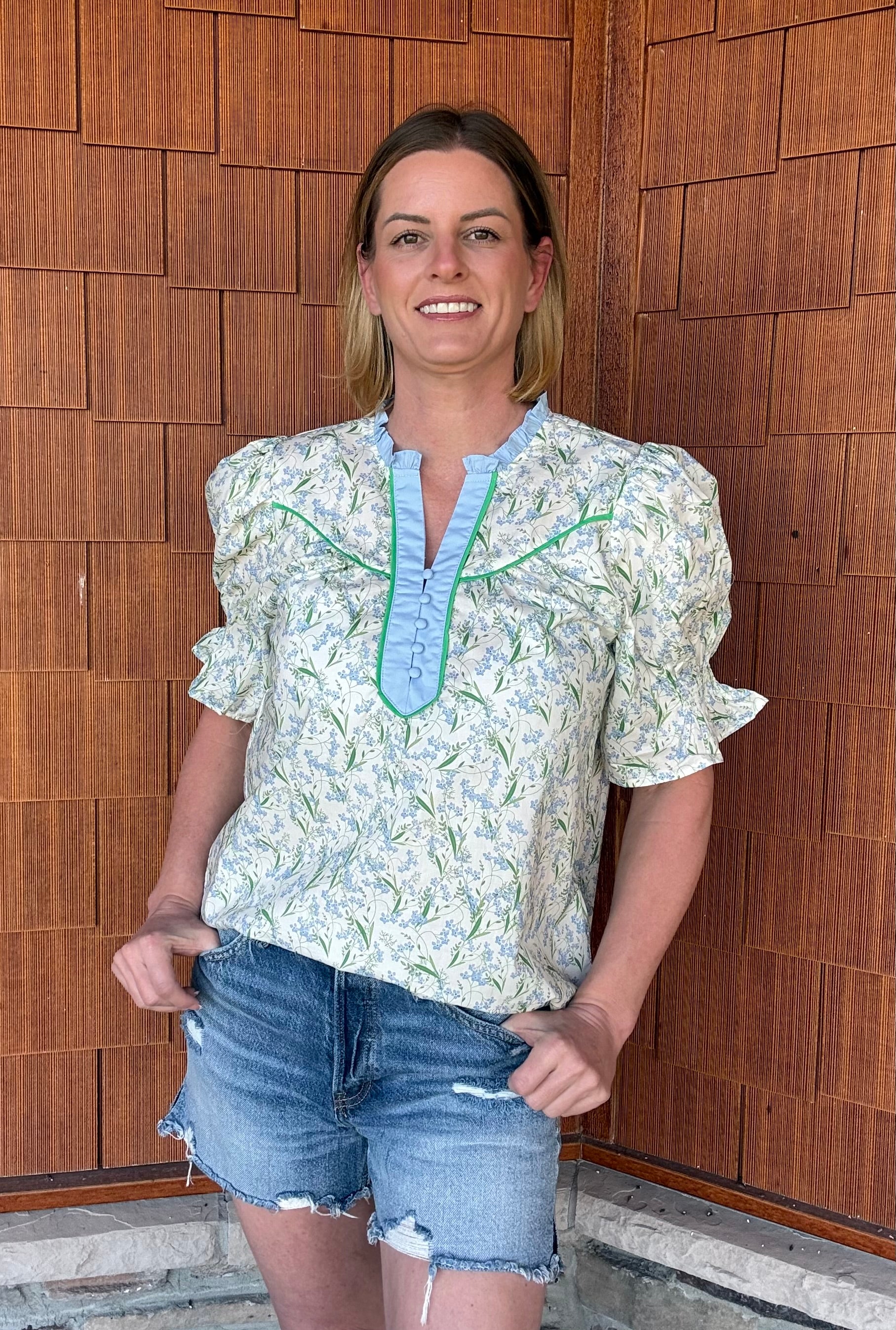Brooke & Co spring meadow top in blue and green floral styled with denim shorts, everyday outfit front view