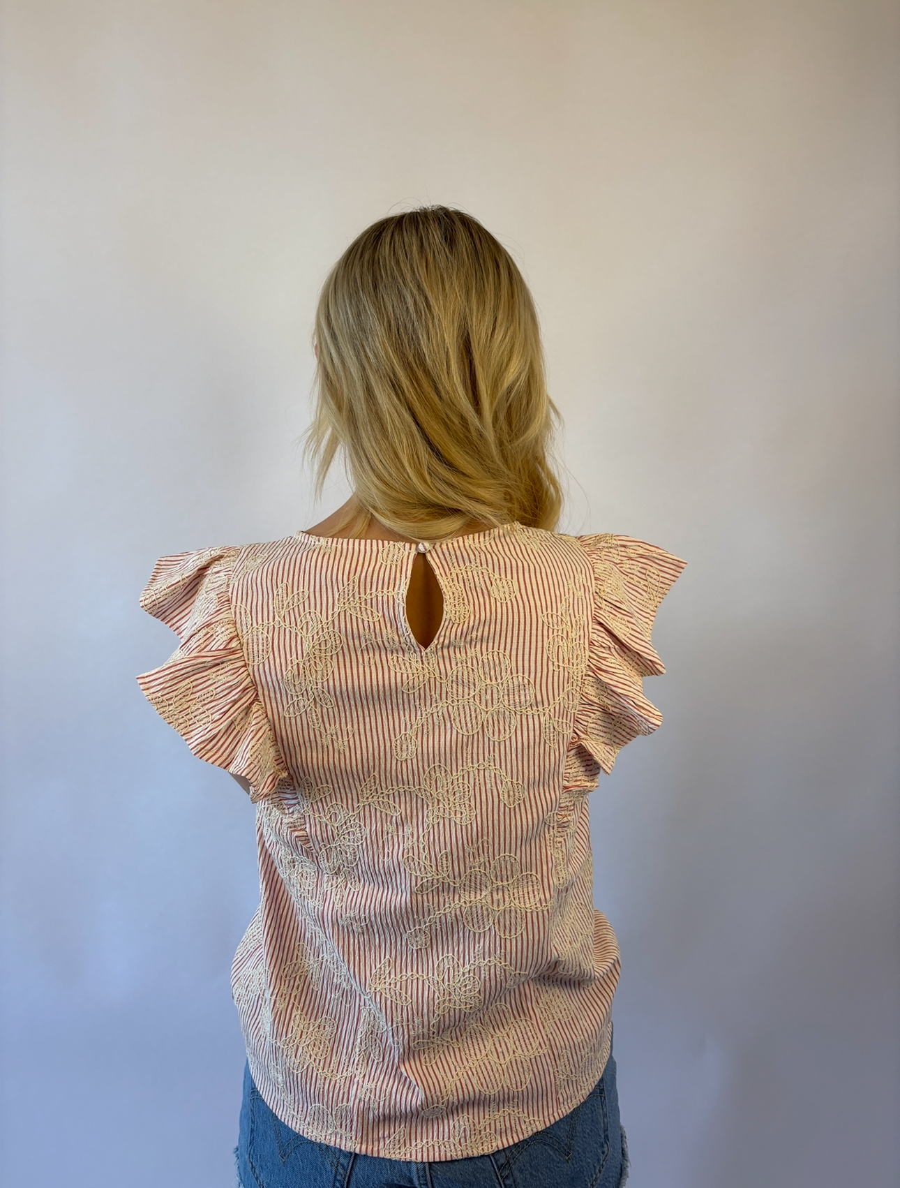 Brooke & Co petal striped blouse in red and ivory stripes with ruffle sleeves and flower applique back view