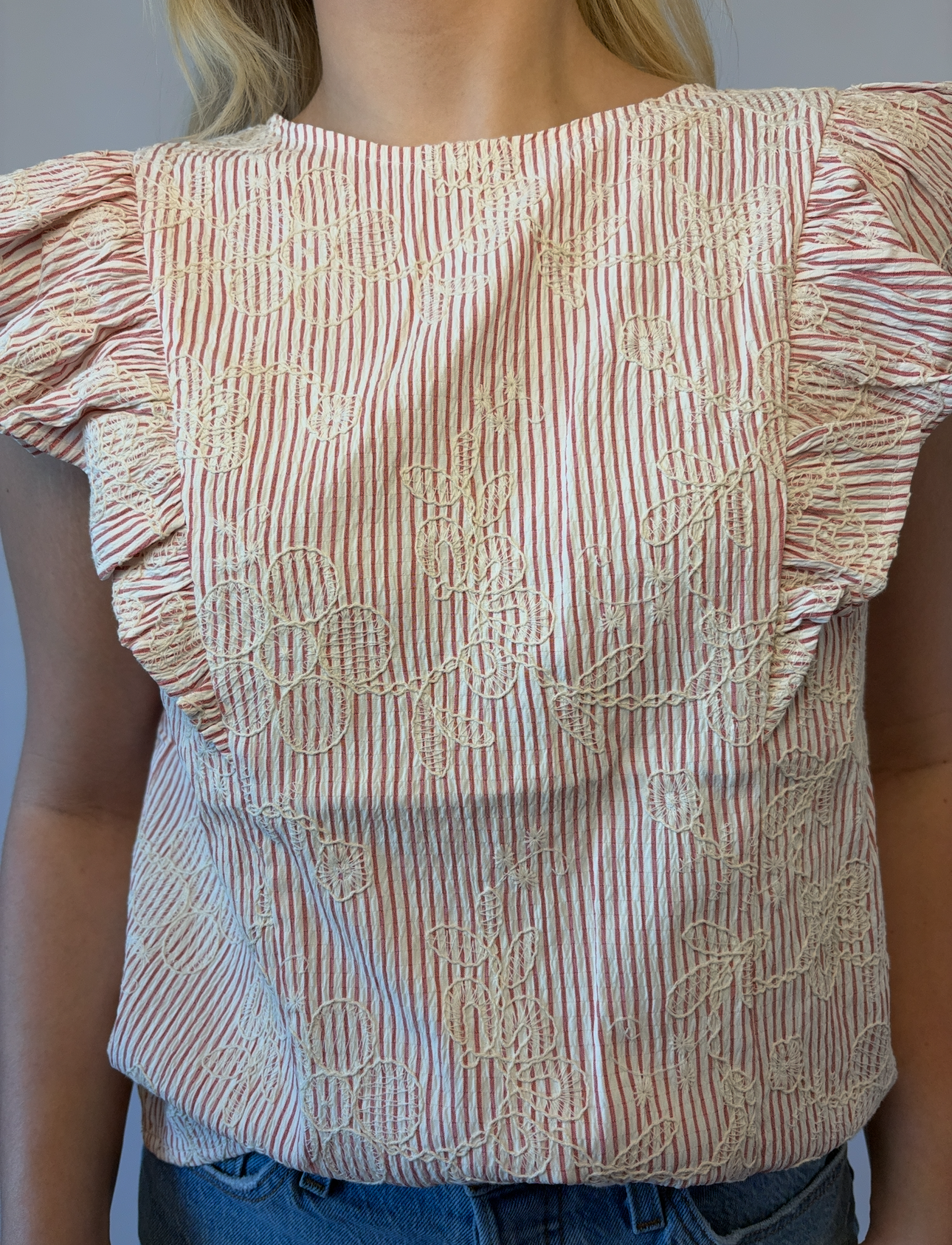 Brooke & Co petal striped blouse in red and ivory stripes with ruffle sleeves and flower applique detail view