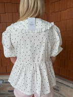 brooke & co polka dot darling white and black polka dot babydoll top with puff sleeves and tie neckline, flowy fit, back view