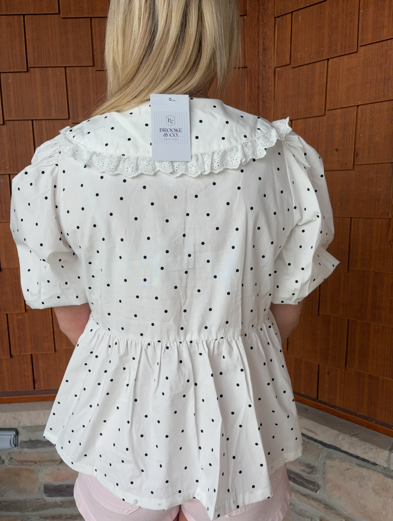 brooke & co polka dot darling white and black polka dot babydoll top with puff sleeves and tie neckline, flowy fit, back view