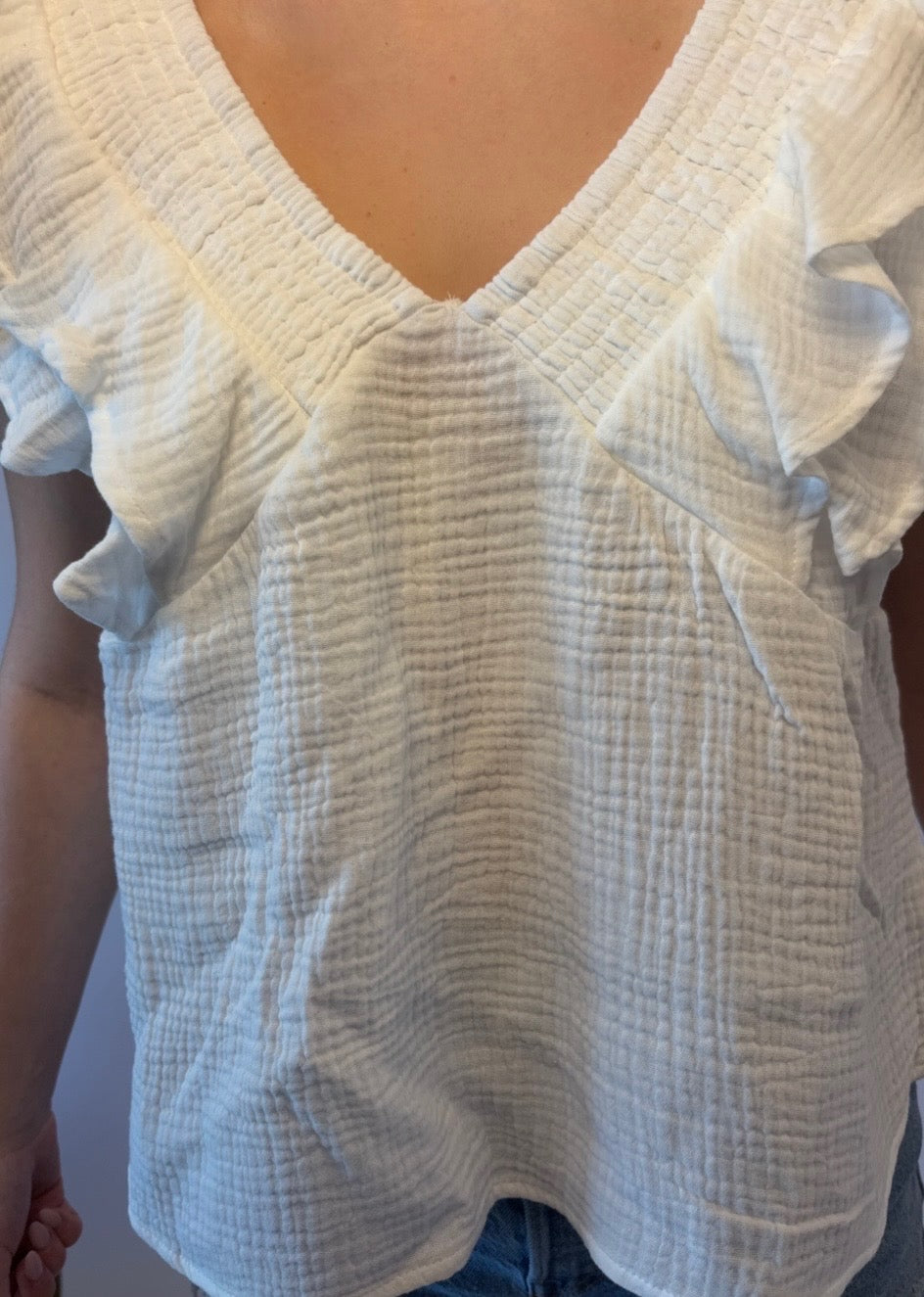 Brooke & Co white willow top in white with ruffle sleeves, v-neck, bow tie in back close up